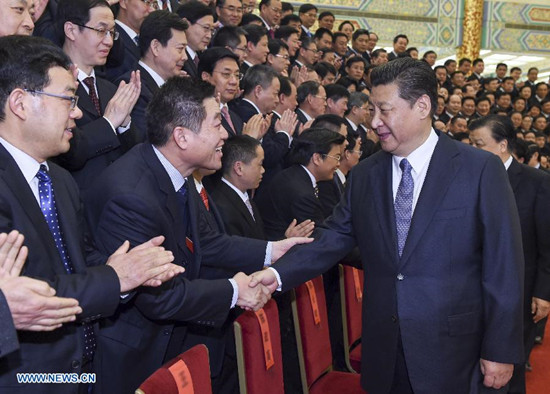 Chinese President Xi Jinping (R front) meets with representatives from cities, towns, villages and units honored by the Central Commission for Guiding Ethic and Cultural Progress at the Great Hall of the People in Beijing, capital of China, Feb. 28, 2015. (Xinhua/Li Xueren)