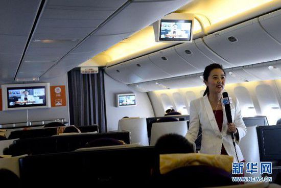 Passengers on flight CA1303 watch a live broadcast of the ongoing 