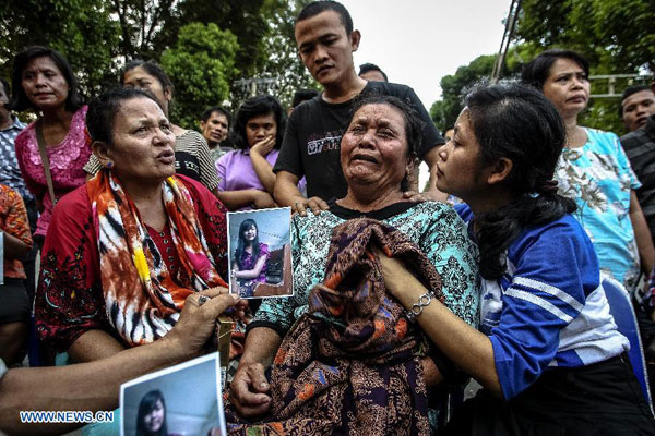 A relative of a victim mourns at a hospital after the crash of an Indonesian military plane Hercules C-130 in the capital of North Sumatra province Medan, Indonesia, on June 30, 2015. 