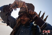 リビアの西南部で、頭巾を巻きなおす反政府武装兵