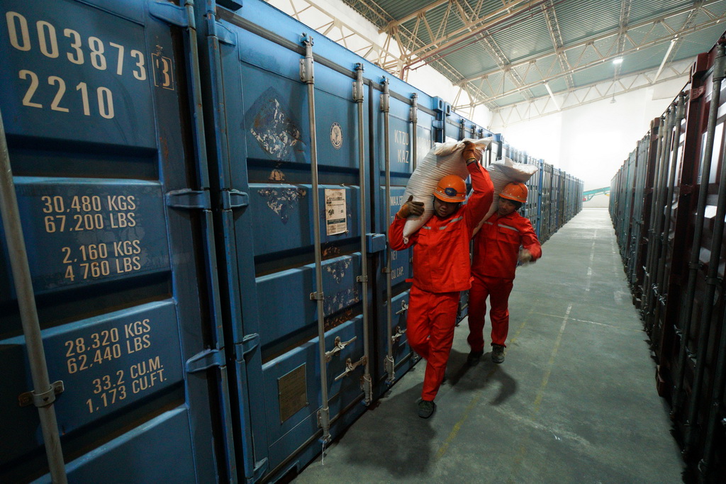  2月5日，在中哈连云港物流中转基地，码头工人对过境的哈萨克斯坦小麦进行换装作业。 新华社记者 李响 摄