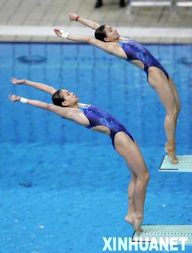 На снимке: Го Цзинцзин (вверху) и У Минься выполняют прыжок. 14 августа 2004 г. на XXVIII Олимпиаде в Афинах Го Цзинцзин и У Минься завоевали первое место в синхронных прыжках в воду с 3-метрового трамплина.
