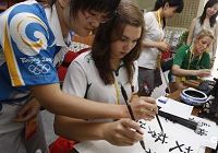 29 июля, в Олимпийской деревне Пекина спортсменка из Ирландии внимательно изучает китайскую каллиграфию.