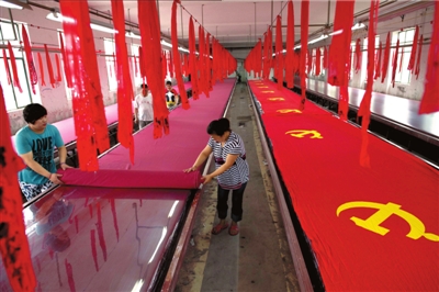 По словам директора пекинской компании по производству флагов господина Лю, процесс изготовления партийного флага охватывает 7 этапов: крашение, подогрев на пару, стирка, шитье, резка, утюжение и отделка. 