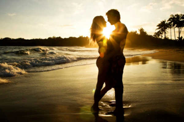 En la playa. Compartir un viaje es una de las experiencias más bonitas para una pareja, es por ello que darse un beso al atardecer en alguna playa es especial.