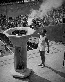 British athlete John Mark lights the Olympic Flame at the opening ceremony of the Olympic Games at Wembley Stadium, London, on July 29, 1948.