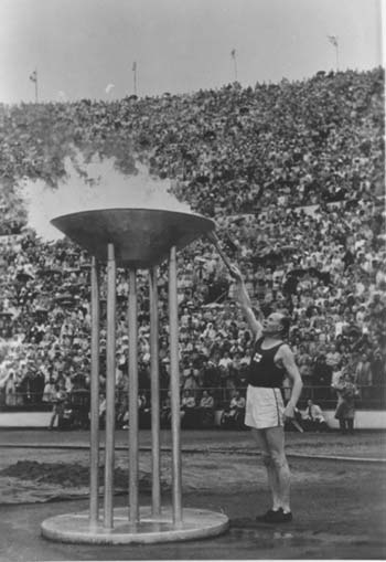 Paavo Nurmi of Finland lights the Olympic Flame during the opening ceremony of the 1952 Olympic Games in Helsinki, Finland, on July 19, 1952.