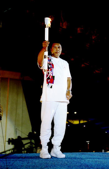 Muhammad Ali holds the torch before lighting the Olympic Flame during the opening ceremony of the 1996 Centennial Olympic Games in Atlanta, Georgia, on Jul 19, 1996.
