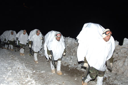 Turkish soldiers with white cloth as covering walk at night in the cross-border operation in Iraq on Feb. 22, 2008. Turkish Foreign Minister Ali Babacan said on Tuesday that objective and scope of the Turkish military operation into northern Iraq is well-known and the operation will continue till it reaches its goal. 