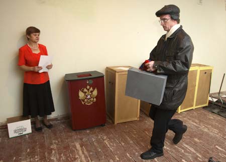 A local election official (R) carries ballot boxes for the coming presidential elections in Russia's Siberian town of Divnogorsk, 38km (24 miles) from Krasnoyarsk, Feb. 28, 2008. (Xinhua/Reuters Photo)