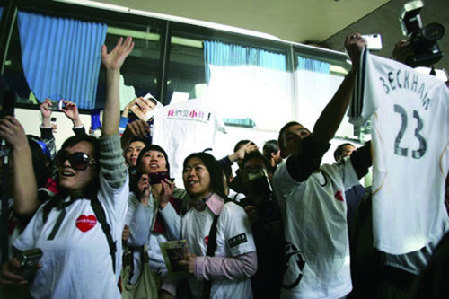 Chinese fans welcome Former England football captain David Beckham at Pudong International Airport in Shanghai on Sunday, March 2, 2008. 
