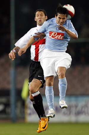 Inter Milan's Marco Materazzi (L) and Napoli's Ezequiel Lavezzi jump for the ball during their Italian Serie A soccer match at the San Paolo stadium in Naples March 2, 2008.