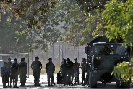 Venezuelan soldiers lines up prior to board a military transport at Fort Paramacay in Valencia, Venezuela, Sunday, March 2, 2008. 