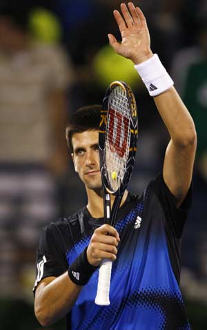 Serbia's Novak Djokovic waves after winning the match against Croatia's Marin Cilic at the ATP Dubai Tennis Championships, March 4, 2008.