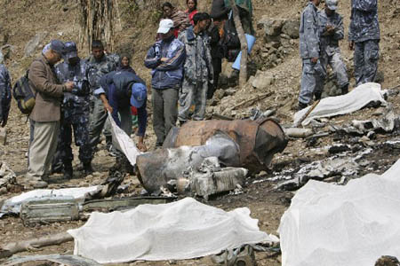 Officials examine the bodies and the crash site at a hill in Ramechhap, Kathmandu, March 4, 2008. Ten people were killed when a helicopter carrying United Nations officials crashed in bad weather over hilly terrain near Nepal's capital on Monday, police and airport officials said.