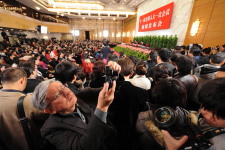 Journalists are busy working during the news conference on the First Session of the 11th National People's Congress (NPC) at the Great Hall of the People in Beijing, capital of China, March 4, 2008. (Xinhua/Yang Zongyou) 