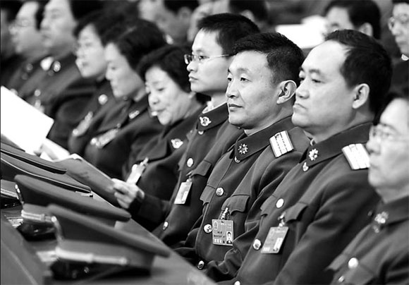 Deputies of the PLA delegation attend a meeting yesterday ahead of the opening of the first session of the 11th NPC.