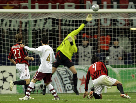 Arsenal's Cesc Fabregas (second left) watches as his shot hits the crossbar during their Champions League first knockout round, second leg match against AC Milan in Milan on Tuesday. Arsenal won 2-0.