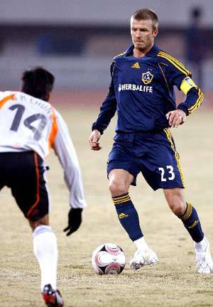 Shanghai Hong Kong United's Jason Chung Kim Hei tries to block a shot by Los Angeles Galaxy's David Beckham during a soccer match performance against Shanghai Hong Kong United in Shanghai, east China, March 5, 2008. Los Angeles Galaxy won 3-0. 