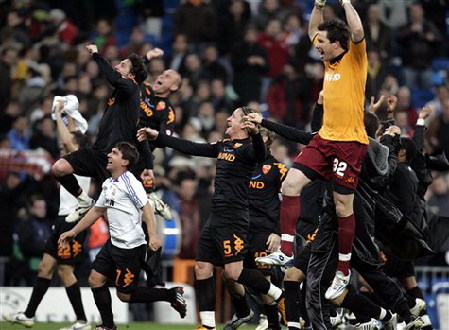 AS Roma's players celebrate at the end of the Champions League second round soccer match between Real Madrid and AS Roma in Madrid yesterday. Roma won 2-1.