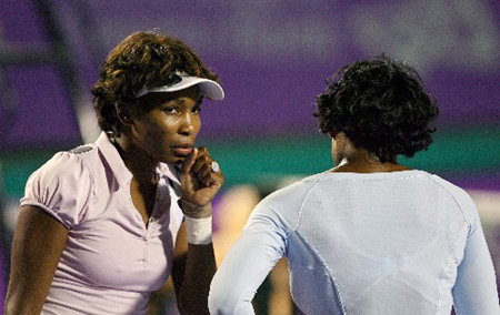 Serena Williams and Venus Williams (L) of U.S. discuss during their match against China's Peng Shuai and Sun Tiantian at the WTA Bangalore Open tennis tournament in the southern Indian city of Bangalore March 5, 2008. 