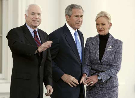 U.S. President George W. Bush welcomes Republican Presidential hopeful Sen. John McCain (L) and his wife Cindy to the White House in Washington March 5, 2008. McCain scored victories in Texas, Ohio, Vermont and Rhode Island on Tuesday to complete his improbable comeback from the political graveyard last summer to become his party's standard-bearer.