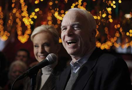 Republican presidential candidate U.S. Senator John McCain (R-AZ) (R), speaks to reporters as his wife, Cindy, looks on at Mi Tierra Restaurant in San Antonio, Texas March 4,2008. 