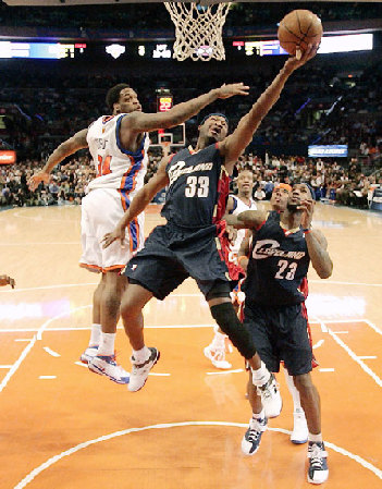 Cleveland Cavaliers' Devin Brown (center) drives past New York Knicks' Eddie Curry (left) as Cavaliers' LeBron James looks (right) looks on during the first quarter in New York on Wednesday. The Cavs won 119-105.