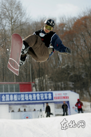 A skier competes in the 2007-2008 National Snowboard Halfpipe Championship at the Harbin Institute of Physical Education Ski Resort in northern China's Heilongjiang Province on Thursday, March 6, 2008.