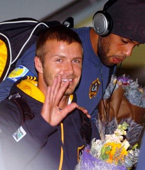 Los Angeles Galaxy's David Beckham waves to people upon his arrival in Hong Kong, south China, March 6, 2008. Los Angeles Galaxy will play with Hong Kong Union on March 9. 