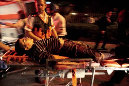 An injured Israeli youth is evacuated from the scene of a shooting attack in Jerusalem March 6, 2008. 