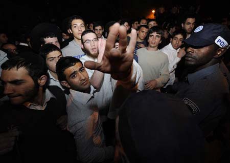 Angry Jewish students clash with policemen outside a Jewish religious school after a shooting attack in Jerusalem on March 6, 2008. At least eight Israeli students were killed in the shooting attack at Merkaz Harav yeshiva in the Kiryat Moshe neighborhood of Jerusalem on Thursday.