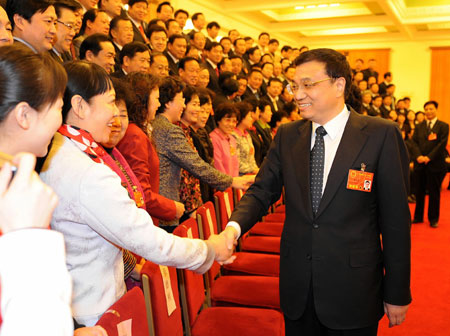 Li Keqiang (R front), member of the Standing Committee of the Political Bureau of the Communist Party of China (CPC) Central Committee, meets with deputies to the First Session of the 11th National People's Congress (NPC) from north China's Hebei Province in Beijing, China, March 8, 2008. Li Keqiang joined in the panel discussion of Hebei delegation on Saturday during the First Session of the 11th NPC.