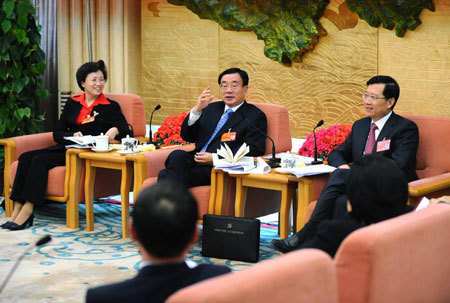 He Guoqiang (2nd L), member of the Standing Committee of the Political Bureau of the Communist Party of China (CPC) Central Committee, meets with deputies to the First Session of the 11th National People's Congress (NPC) from northwest China's Qinghai Province in Beijing, China, March 8, 2008. He Guoqiang joined in the panel discussion of Qinghai delegation on Saturday during the First Session of the 11th NPC.