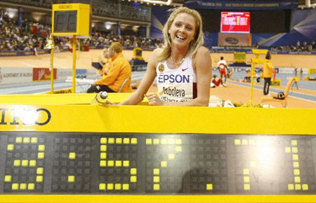 Russia's Yelena Soboleva poses behind a stopwatch showing the world record she set in the women's 1500m final at the 12th IAAF World Indoor Athletics Championship in Valencia March 9, 2008. 