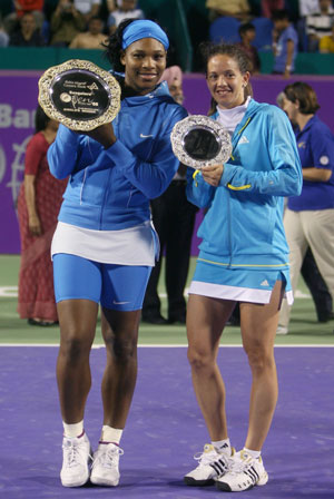 Serena Williams of the U.S. holds her trophy after defeating Switzerland's Patty Schnyder (R) during their final match at the WTA Bangalore Open tennis tournament March 9, 2008.