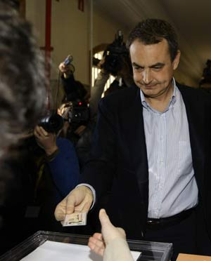 Spanish Prime Minister Jose Luis Rodriguez Zapatero shows his identity card as he casts his ballot in Spain's general elections at a Madrid polling station March 9, 2008.