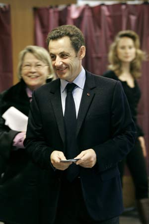 France's President Nicolas Sarkozy waits to cast his ballot in the first round local elections in Paris March 9, 2008.