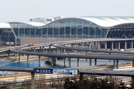 Photo taken on March 7, 2008 shows the exterior of newly-built No.2 terminal building of the Pudong International Airport in Shanghai, east China. (Xinhua Photo)