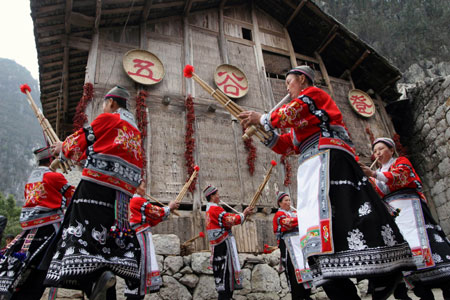 Women of the Miao ethnic group perform during the opening ceremony of the 6th Guizhou (Anshun Longgong) Cole Flower Tour Festival at the Longgong scenic area in Anshun City, southwest China's Guizhou Province, March 8, 2008. (Xinhua Photo)