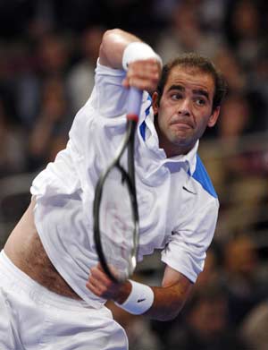 Pete Sampras of the U.S. serves to Roger Federer of Switzerland during the first set of their exhibition match at New York's Madison Square Garden, March 10, 2008.