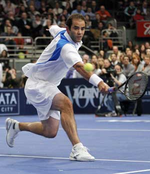 Pete Sampras of the U.S. hits a return to Roger Federer of Switzerland during the first set of their exhibition tennis match at New York's Madison Square Garden, March 10, 2008.