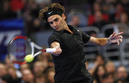 Roger Federer of Switzerland hits a return to Pete Sampras of the U.S. during their exhibition tennis match at New York's Madison Square Garden, March 10, 2008.