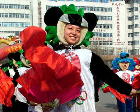 Actors wearing the costume of the mascot of 2008 Beijing Olympic Games perform yangge dance, a traditional rural folk dance, in Mudanjiang city, northeast China's Heilongjiang province, March 9, 2008. A spring yangge performance was held in the city on Sunday, in which the modern yangge performance staged by a group of young dancers attracted many citizens.