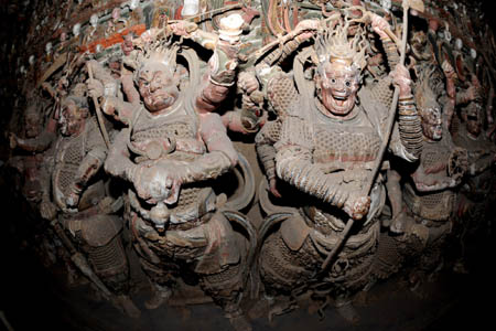 Photo taken on March 7, 2008 shows a set of earth sculptures in Shuilu Buddhist Nunnery at the foot of Mountain Wangshun in Lantian county of northwest China's Shaanxi Province. Shuilu Buddhist Nunnery, one of key historical relics under state protection, possesses in the main hall a fine collection of over 3,000 pieces of earth mural sculptures that can be traced back to more than 1,000 years. 