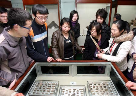 Japanese students visit a museum of ancient currency at East China Normal University in Shanghai of China, March 11, 2008. A total of 1,000 Japanese youth arrived in China on Monday for a seven-day tour of the country to mark the start of the China-Japan Friendly Exchange Year of the Youth. The Japanese delegation, breaking into small groups, will respectively visit such cities as Shanghai and Hangzhou in the east, Chongqing and Chengdu in the west, Guangzhou in the south and Dalian in the northeast and hold get-togethers with their Chinese peers.