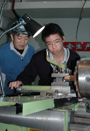 A Japanese student tries a lathe as he visits a vocational school in Dalian of northeast China's Liaoning Province on March 11, 2008. A total of 1,000 Japanese youth arrived in China on Monday for a seven-day tour of the country to mark the start of the China-Japan Friendly Exchange Year of the Youth. The Japanese delegation, breaking into small groups, will respectively visit such cities as Shanghai and Hangzhou in the east, Chongqing and Chengdu in the west, Guangzhou in the south and Dalian in the northeast and hold get-togethers with their Chinese peers.