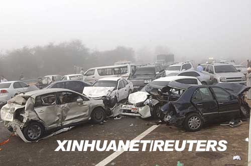 Damaged vehicles are seen after a pile-up during morning rush hour on the main motorway between Dubai and Abu Dhabi in the Ghantout area March 11, 2008. Three people were killed and 277 injured in the United Arab Emirates on Tuesday when dozens of cars and buses collided in thick fog in what could be the country's biggest traffic accident, police said. 