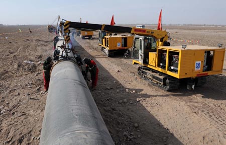 Photo taken on March 10, 2008 shows the construction site of the second project of west-to-east natural gas transmission pipeline in Fengle Town of Wuwei City, northwest China's Gansu Province. The pipeline will carry natural gas from Turkmenistan and China's Xinjiang Uygur Autonomous Region to the central and west China’s areas as well as the Yangtze and Pearl River deltas. The 9,102-kilometer pipeline that is under construction consists of a main line and eight sub-lines traversing 14 provinces, autonomous regions and the municipality Shanghai. The pipeline’s designed gas transmission capacity is 30 billion cubic meters annually and the total investment on the project is 142.2 billion yuan (about 20 billion U.S. dollars) 