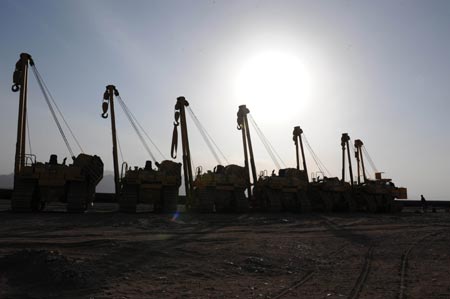 Cranes are silhouetted at the construction site of the second project of west-to-east natural gas transmission pipeline in Fengle Town of Wuwei City, northwest China's Gansu Province. The pipeline will carry natural gas from Turkmenistan and China's Xinjiang Uygur Autonomous Region to the central and west China’s areas as well as the Yangtze and Pearl River deltas. The 9,102-kilometer pipeline that is under construction consists of a main line and eight sub-lines traversing 14 provinces, autonomous regions and the municipality Shanghai. The pipeline’s designed gas transmission capacity is 30 billion cubic meters annually and the total investment on the project is 142.2 billion yuan (about 20 billion U.S. dollars) 